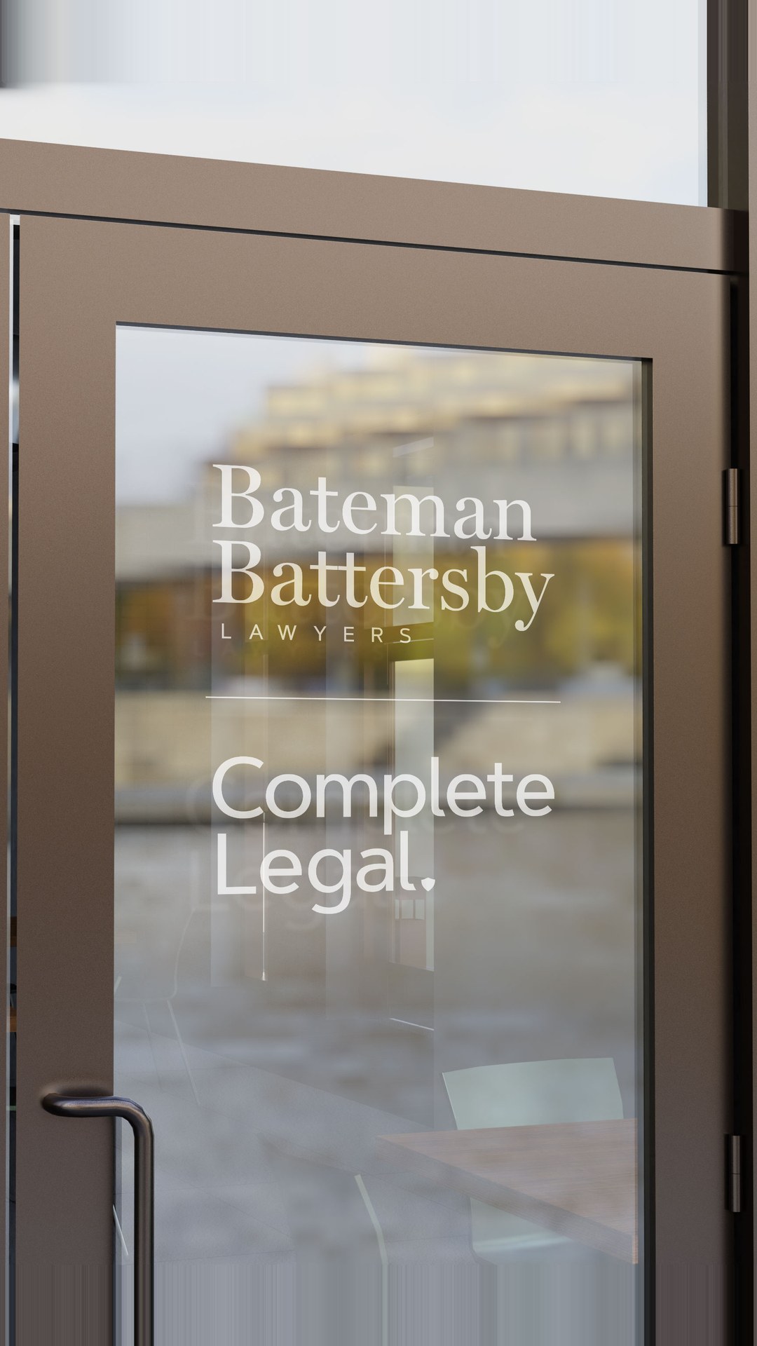 Glass door printed with the Bateman Battersby and Complete Legal logos