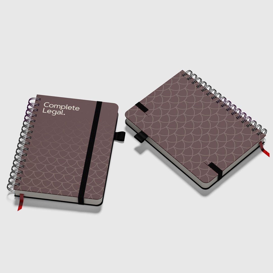 Two notebooks with a scale pattern cover and the Complete Legal logo