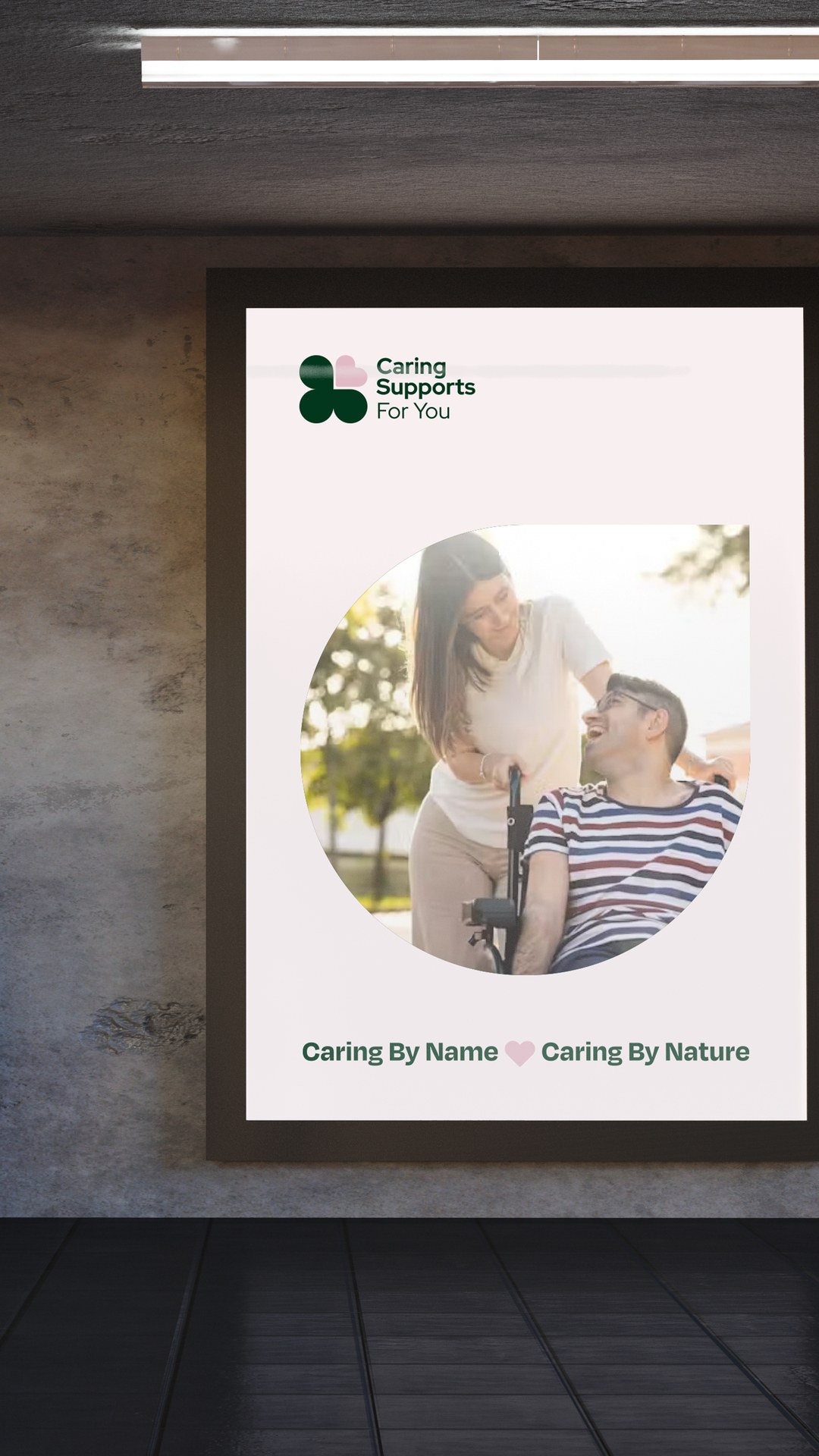 Poster of two people smiling outdoors, one using a wheelchair, with the line Caring By Name, Caring By Nature