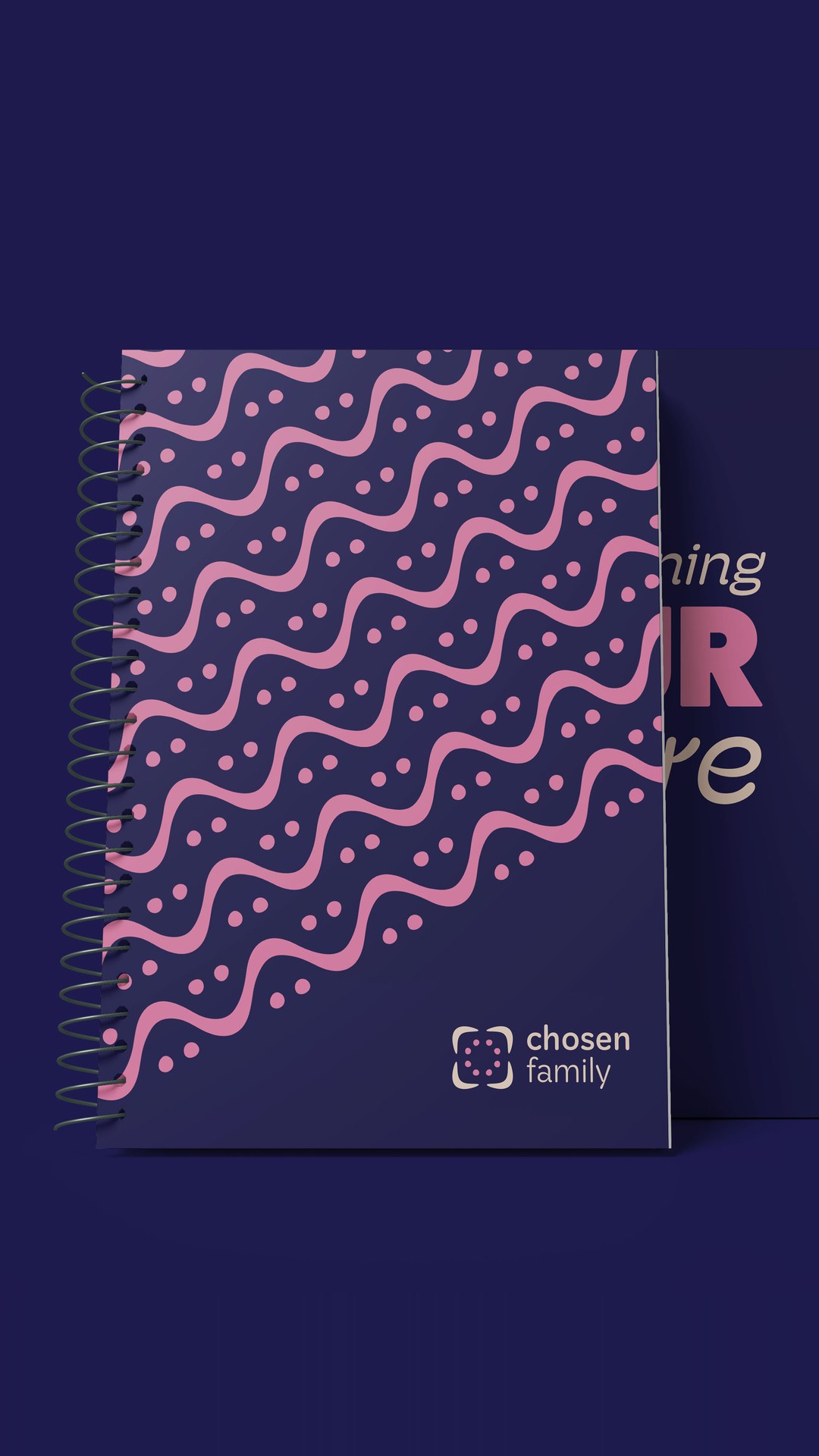 Navy spiral notebook with a pink wave pattern and the logo
