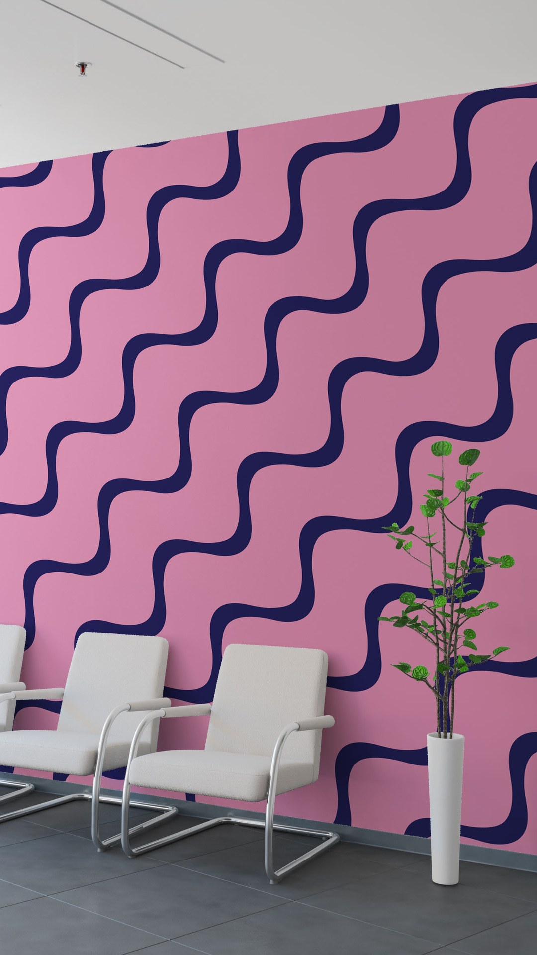 Reception wall covered in the pink and navy wave pattern, with white chairs