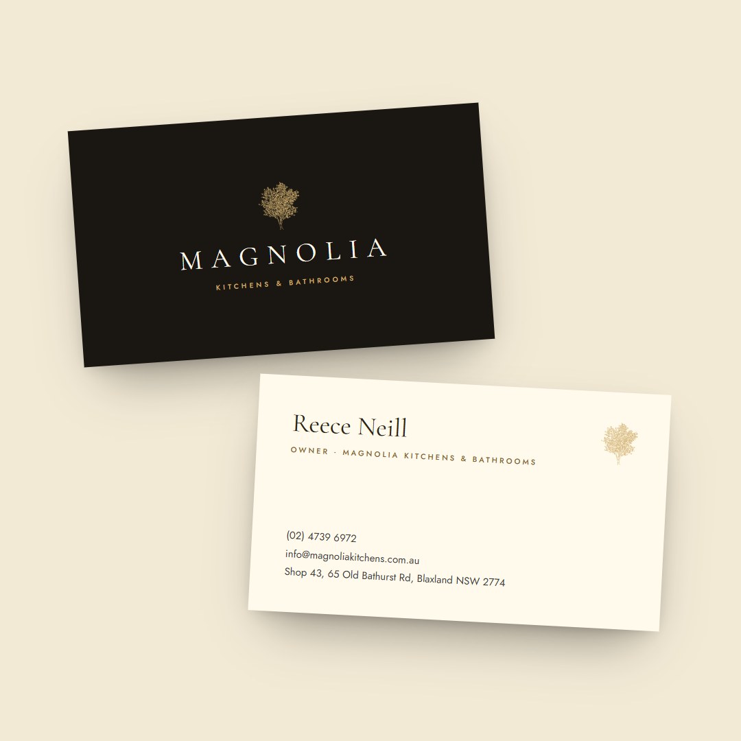 Magnolia business cards for Reece Neill, front and back, on a sand background