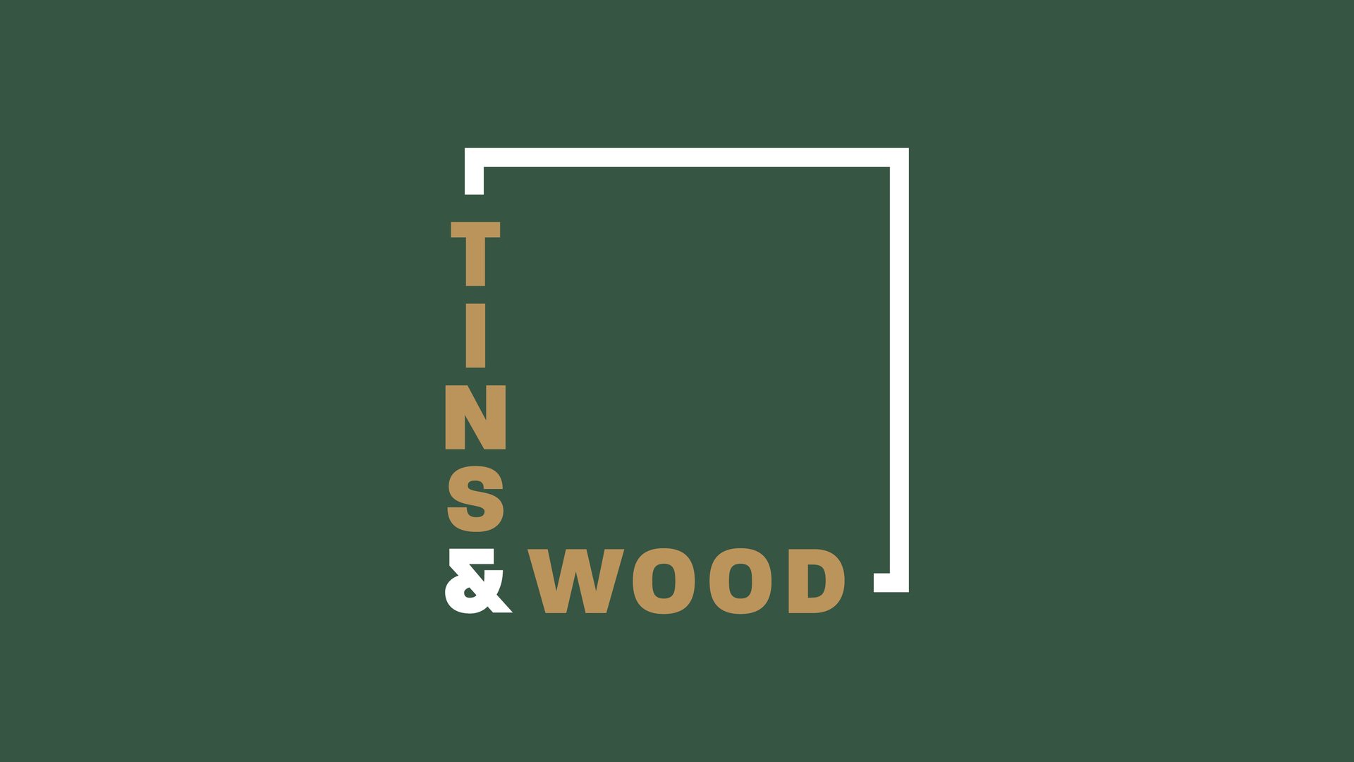 Tins & Wood logo, stacked tan and white lettering inside a white corner bracket, on deep green